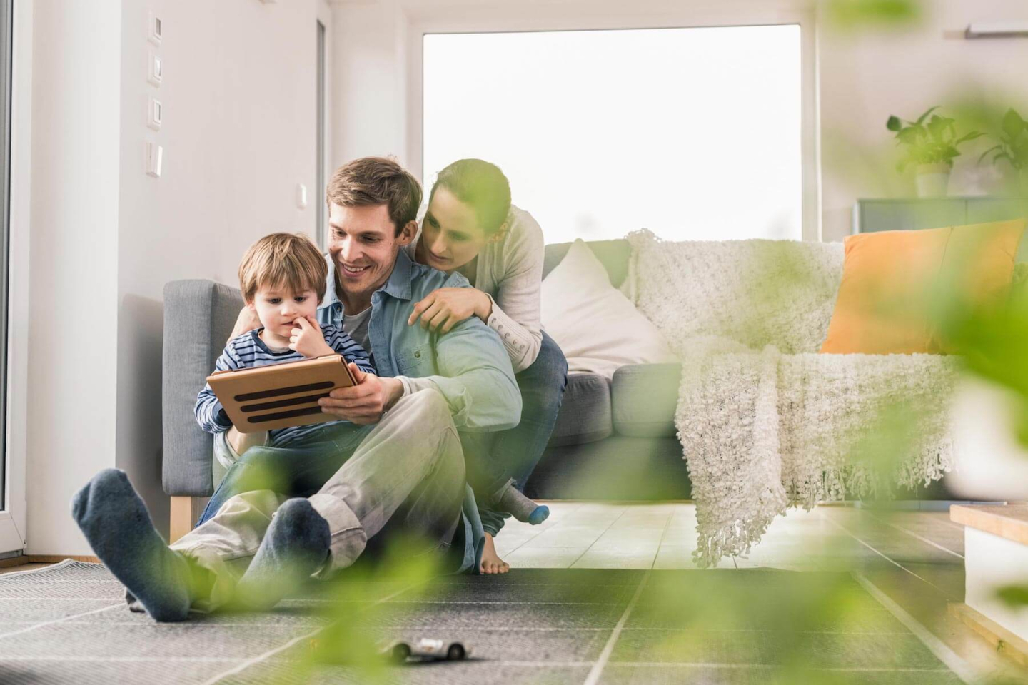 Seguro Futuro Garantizado: Una familia en la sala de una casa leyendo 